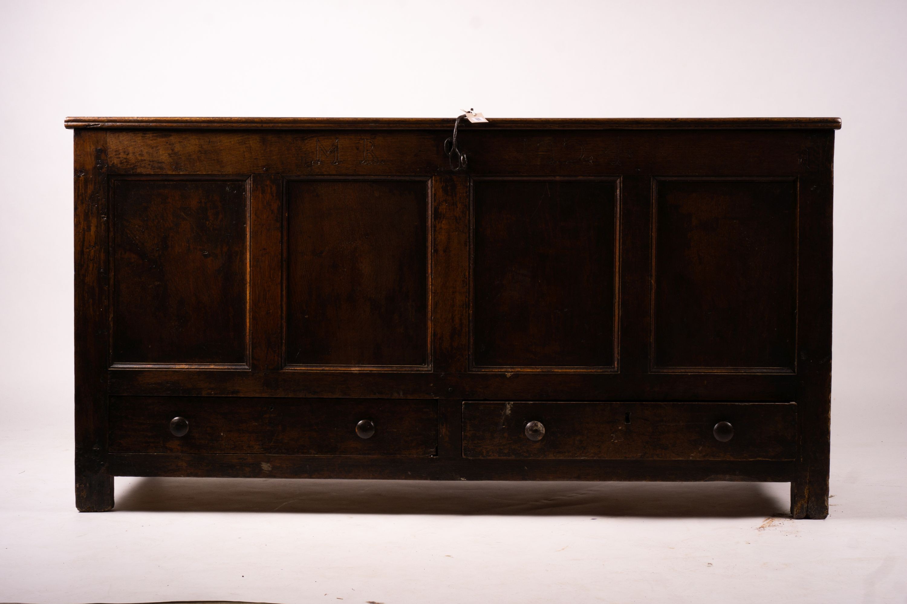 An 18th century panelled oak mule chest, length 161cm, depth 61cm, height 84cm